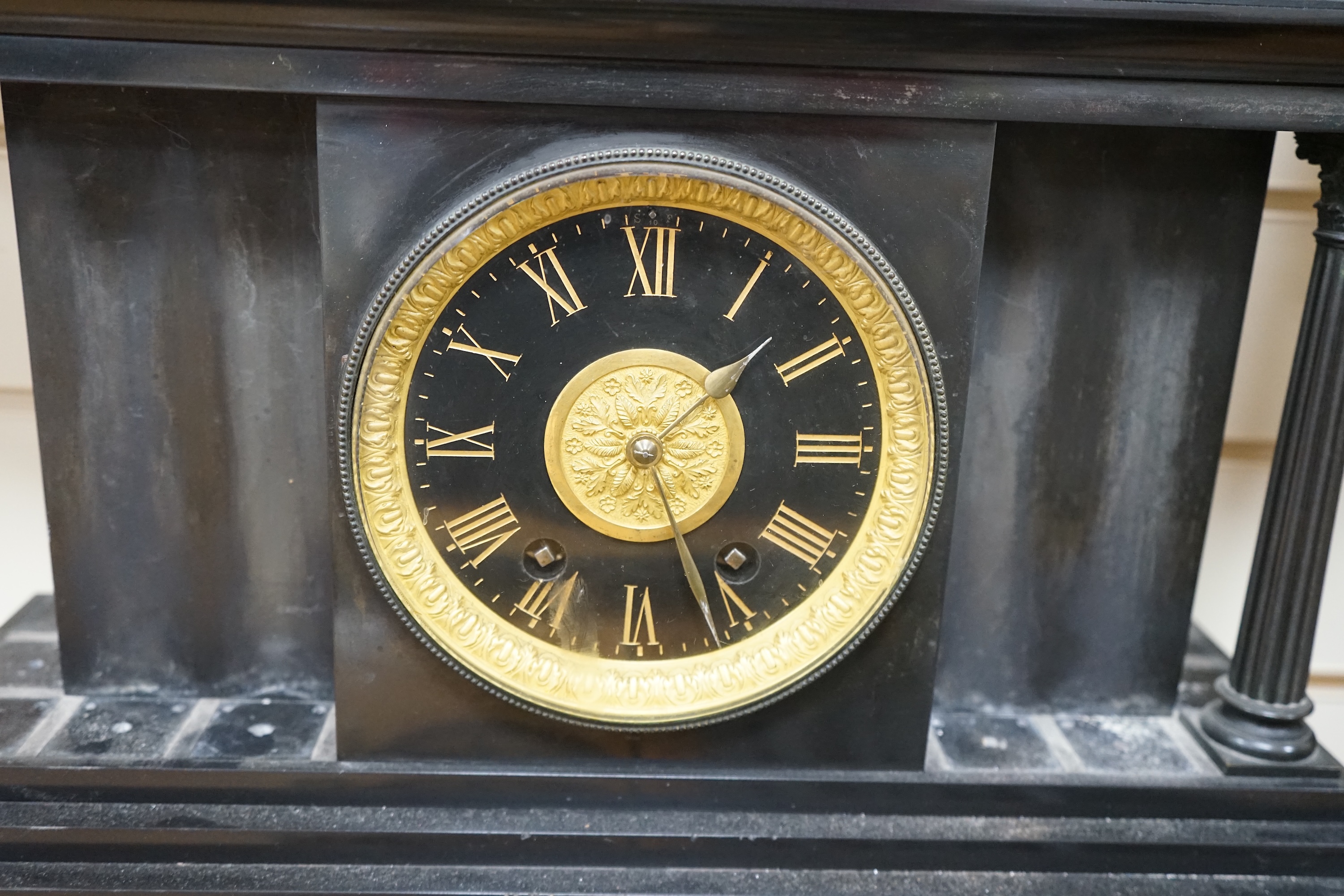 A Victorian black slate mantel clock, 54.5cm wide. Condition - columns and some clock parts loose